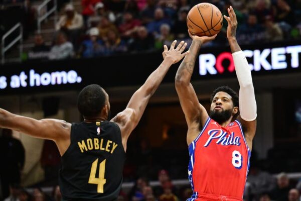 Dec 21, 2024; Cleveland, Ohio, USA; Philadelphia 76ers forward Paul George (8) shoots over the defense of Cleveland Cavaliers forward Evan Mobley (4) during the first half at Rocket Mortgage FieldHouse. Mandatory Credit: Ken Blaze-Imagn Images