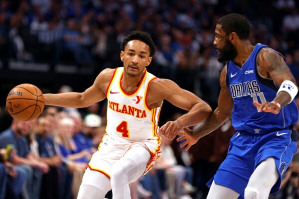 Atlanta Hawks guard Kobe Bufkin, at left driving past Kyrie Irving of Dallas, will miss the remainder of the NBA season with a right shoulder injury and surgery scheduled in January (Ron Jenkins)